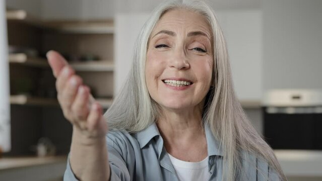 Female portrait caucasian granny old mature hospitable woman gray-haired smiling welcoming homeowner friendly tempting housewife lady asking come here invitation gesture welcome sign appealing to join
