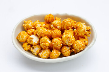 Honey caramel popcorn on white background.