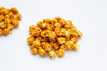 Honey caramel popcorn on white background.