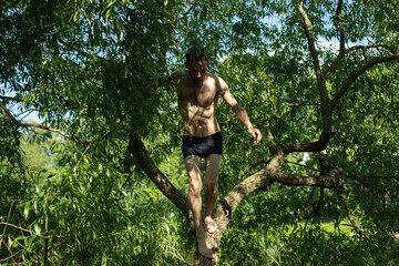 Guy in shade of plants without clothes.