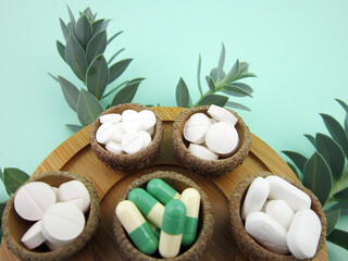   Medicine herb. Herbal pills with healthy medical plant. Green leaf, alternative drug. Natural pharmaceutical capsule. Vitamin supplement for care, medication, treatment.      