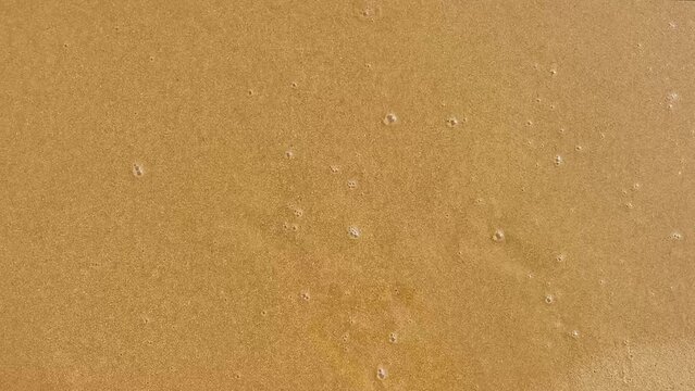 tex on the sand, word love and shape of heart, sea waves erase the words. Concept of love, peace and travelling. High quality FullHD footage