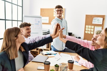 Group of business workers smiling happy celebrating with hands together at the office