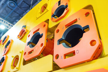 Industrial equipment. Concept of modern production. Yellow orange production equipment. Fragment of production machine close-up. Industrial technological machine indoors. Manufacturing machinery