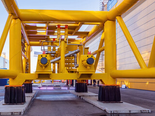 Gas pipes yellow color. Gasification pipeline outside. Gasification industrial enterprise. Boiler station of gas processing factory. Gas pipes with many connections. Compressor station for production