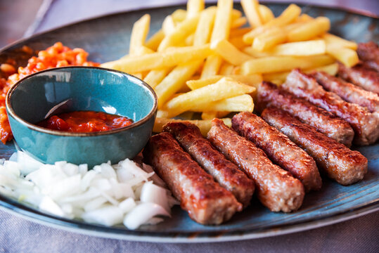 Traditional Cevapcici, ground meat rolls with french fries. Porec, Croatia.