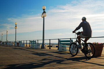 A Male Bicyclist Enjoys an Early Morning Ride on the Boardwalk in Avon on the New Jersey Shore