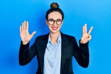 Young hispanic girl wearing business clothes and glasses showing and pointing up with fingers number eight while smiling confident and happy.