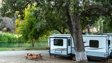 Camping along the river amongst the trees 