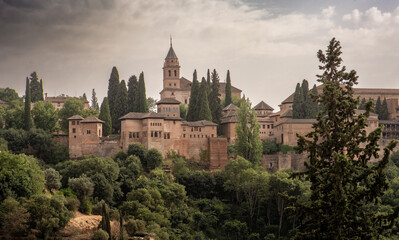 Fototapeta na wymiar The ancient arabic fortress Alhambra at beautiful evening time, Granada, Spain. A European travel landmark and most visited monument in all of Spain 