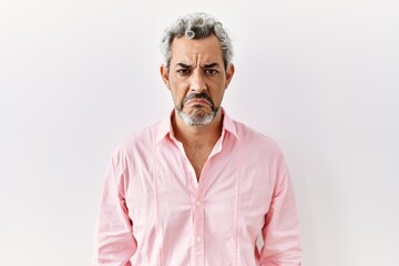 Obraz premium Middle age hispanic man standing over isolated background depressed and worry for distress, crying angry and afraid. sad expression.