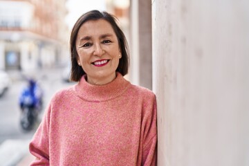 Middle age woman smiling confident standing at street