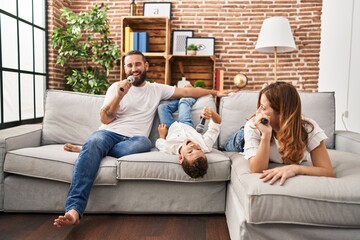 Family singing song using microphone at home