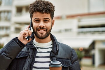 Young arab man speaking on the phone outdoor at the town