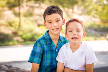 Outdoor portrait of mixed race Chinese and Caucasian brothers.