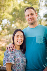 Outdoor portrait of mixed race Chinese and Caucasian couple.