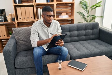 Young african american man psychologist having psychology session at clinic
