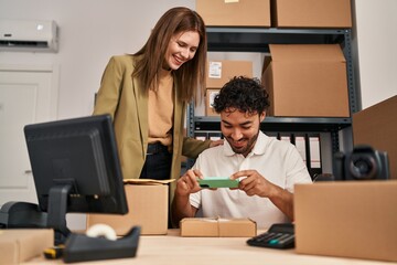 Man and woman business workers make photo to package at office