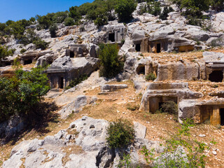 Impressive view of historical remains of Lycian rock tombs on slope of Mount Tocak in ancient city...