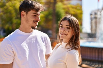 Mand and woman couple smiling confident standing together at park