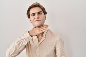 Young man standing over isolated background cutting throat with hand as knife, threaten aggression...