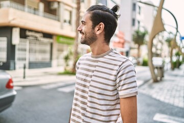 Young hispanic man smiling confident at street