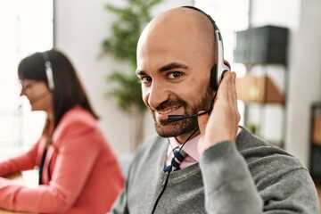 Two call center agent smiling happy working at the office.