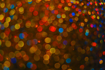 shimmering bokeh.Shiny Festive Background. Lots of Flashing colorful spots background.Multicolored garlands on a black background. Christmas background. Glowing bokeh.soft focus.
