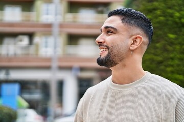 Young arab man smiling confident standing at street