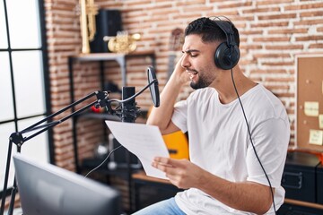 Young arab man artist singing song at music studio