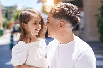 Father and daughter smiling confident standing together at street