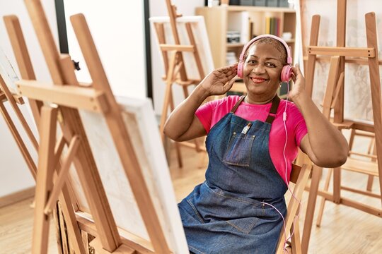 Senior african american woman listening to music drawing at art studio