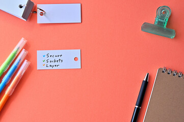 There is word card with the word Secure Socket Layer on the desk.