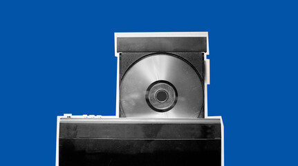 Black and white of dirty dvd player with disk isolated on blue background