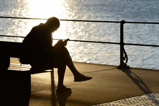 Mobile and Internet Dependency Syndrome (MAIDS), silhouette of a man using his smartphone