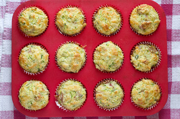 Top View of Zucchini Muffins in Red Baking Tray