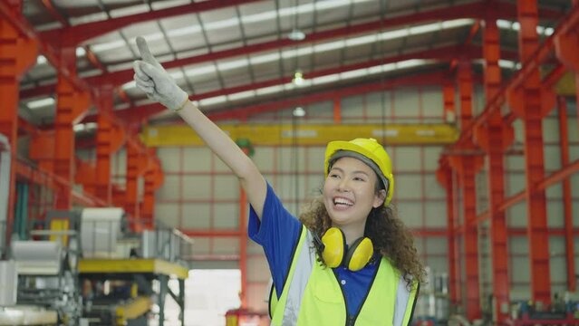 Factory workers are happy and enjoying themselves on a hand pallet truck. Women raise their arms into the air while open arms enjoy colleagues. Slow Motion