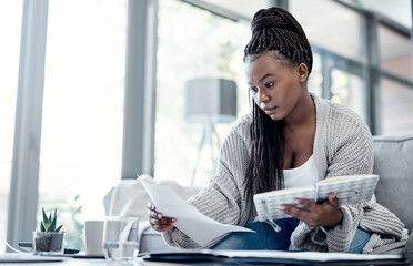 Planning finance, budget and savings with paperwork, bank document and investment report in home living room. Serious, thinking woman reading student loan information and calculating financial future