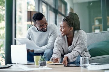 Couple planning finance investments, insurance and banking bills papers together at home. Happy...