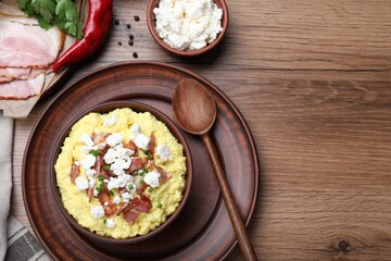 Delicious traditional banosh served on wooden table, flat lay