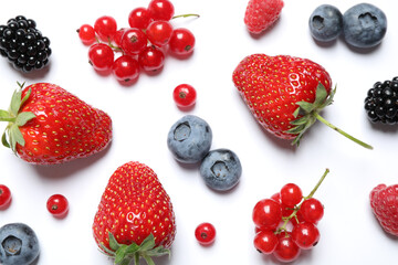 Fototapeta na wymiar Mix of fresh berries on white background, flat lay