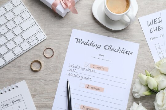 Flat lay composition with Wedding Checklist on wooden table