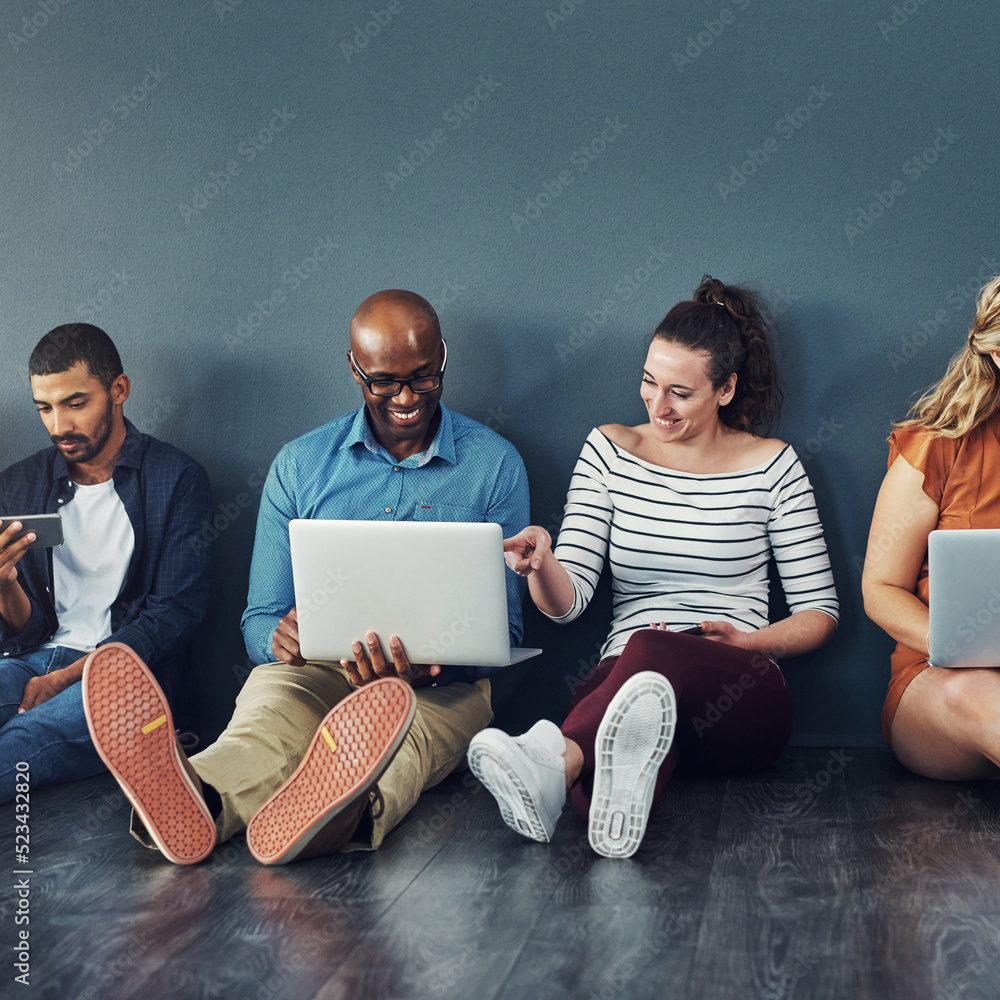 Poster group of happy business people sharing information on wireless technology in a row at an office toge