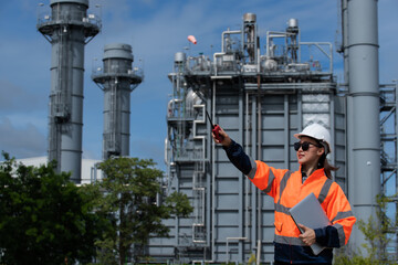 worker in factory. Portrait woman worker in factory with plant. Portrait woman engineer on power plant background. 