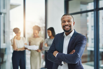 Smiling, happy and modern business man happy about teamwork success and team collaboration. Portrait of a smart and successful boss enjoying his job. Corporate executive leader ready to work