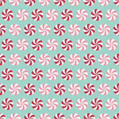 Seamless pattern with peppermint candies. Red and pink mint candies on light blue background.