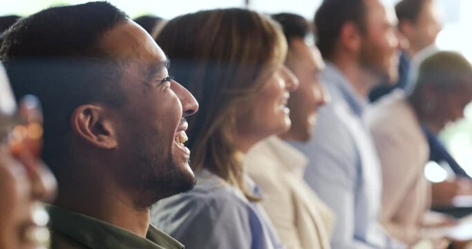 Audience laughing, enjoying and smiling at a funny joke together at a work conference, meeting or presentation. Group of business professionals sitting in a line while having fun at job seminar