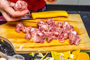 raw pork sausage cut into pieces, preparing dinner