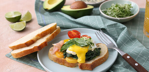 Tasty breakfast with Florentine egg and fresh bread on table