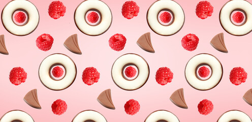 Many tasty chocolate candies and raspberries on pink background. Pattern for design
